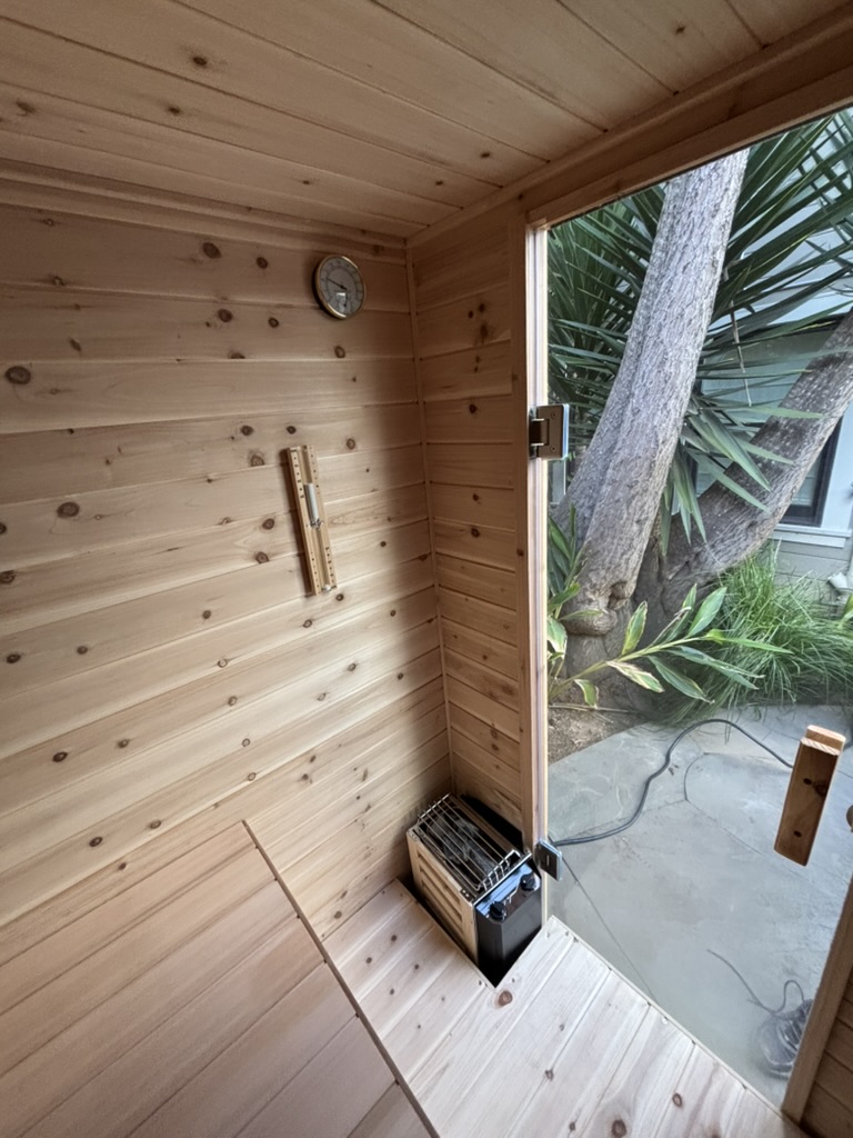 Interior cedar walls of outdoor steam sauna in Bay Area backyard